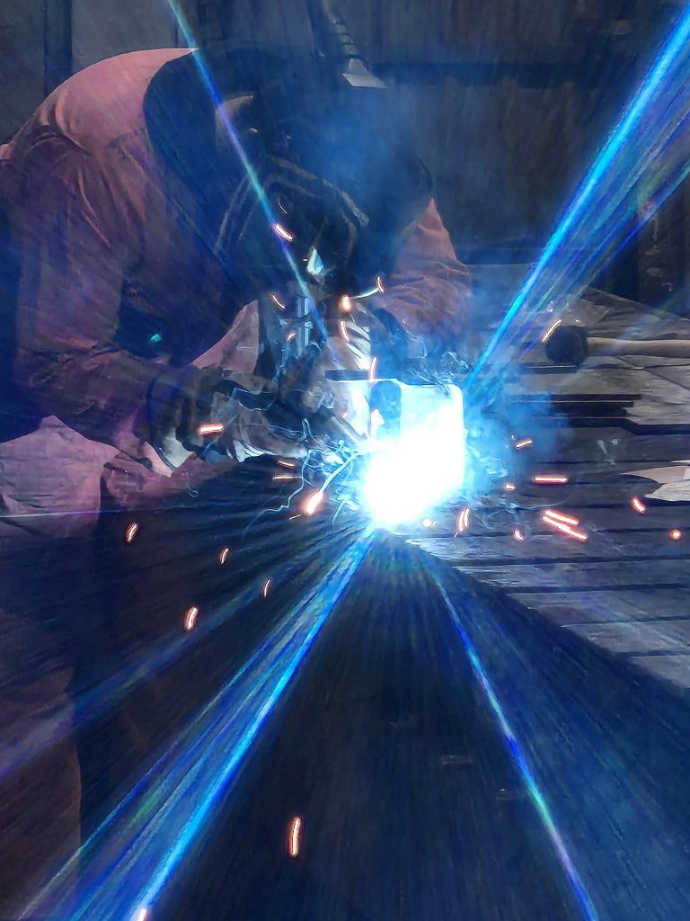 Man welding steel fabricated structure.